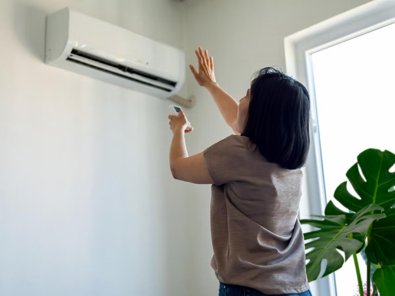 Women checking broken home AC